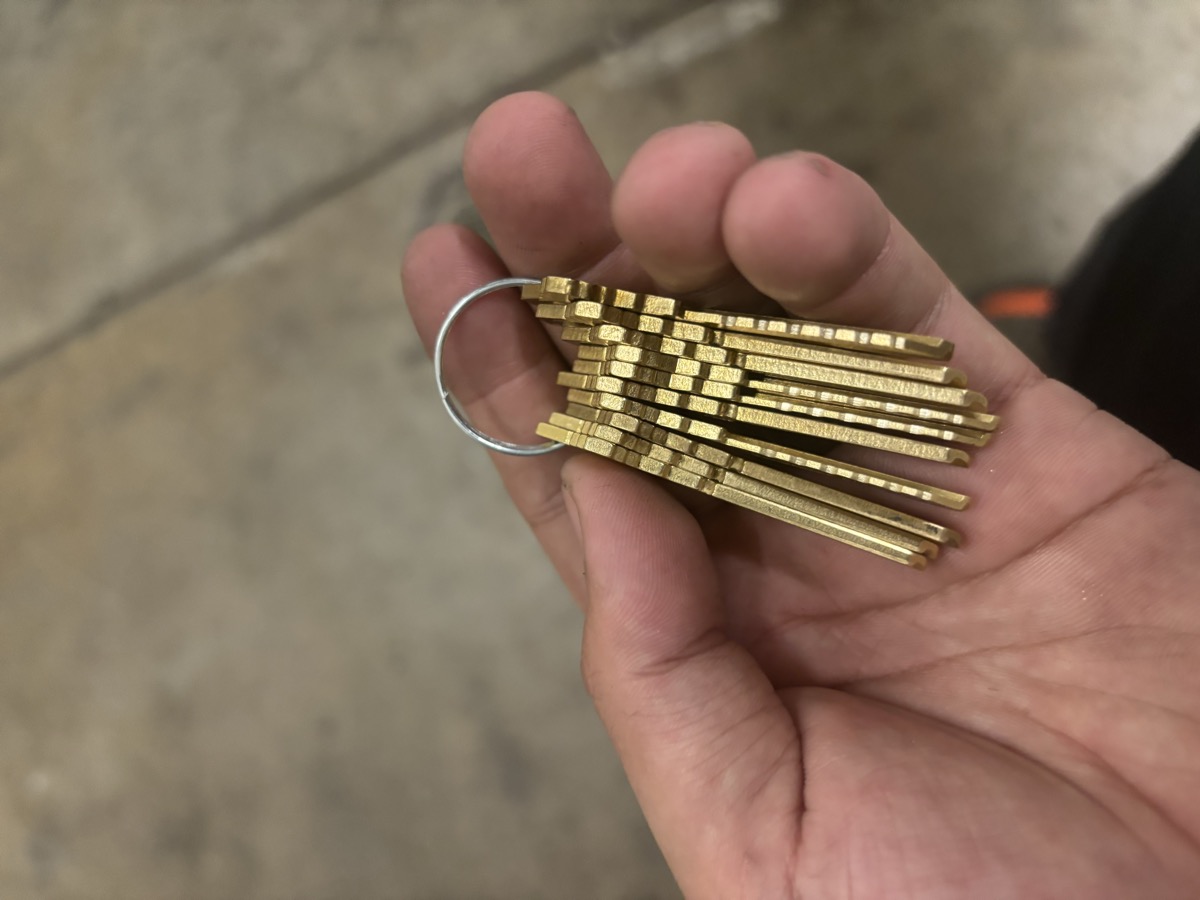 Brass key blanks held by a Right Choice Locksmith technician